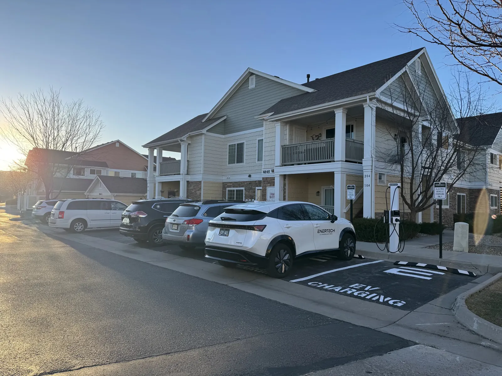 Enertech EV charging station at a Colorado apartment community at sunset